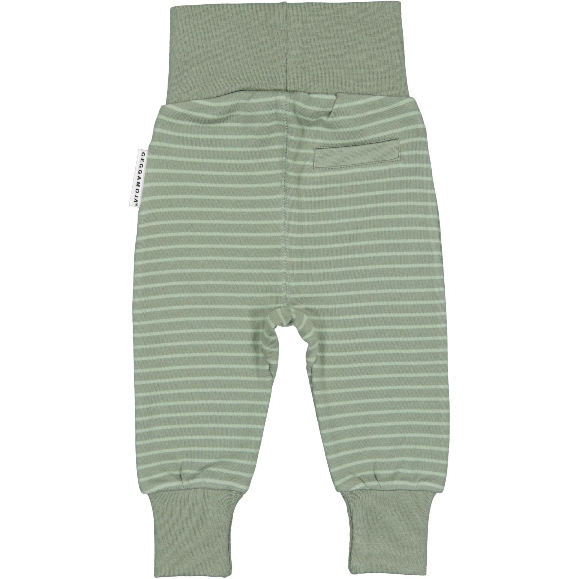 Green-striped organic cotton baby pants with wide cuffs seen from the back by Geggamoja.
